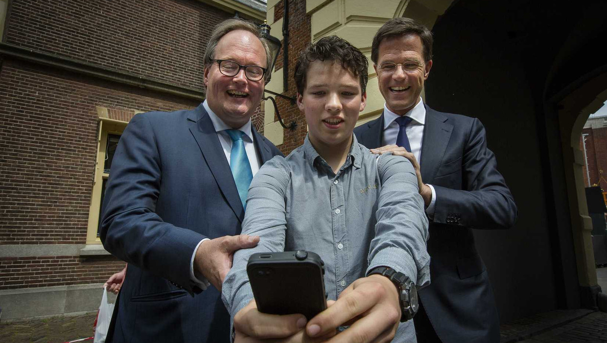 Premier Rutte (rechts) en Hans van Baalen, VVD-lijsttrekker voor het Europees Parlement, maken een selfie met een voorbijganger op het Binnenhof in Den Haag. Beeld anp