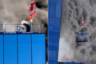 KIJK. Man zit vast op dak van brandend gebouw, maar kan op miraculeuze wijze gered worden
