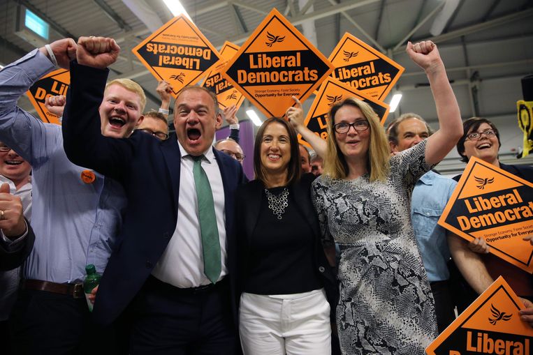 Jane Dodds (midden), kandidaat voor de Liberaal-Democraten, viert met partijgenoot en parlementslid Ed Davey (tweede van links) en haar campagneteam de overwinning bij de lokaleverkiezingen in Wales. Beeld AFP