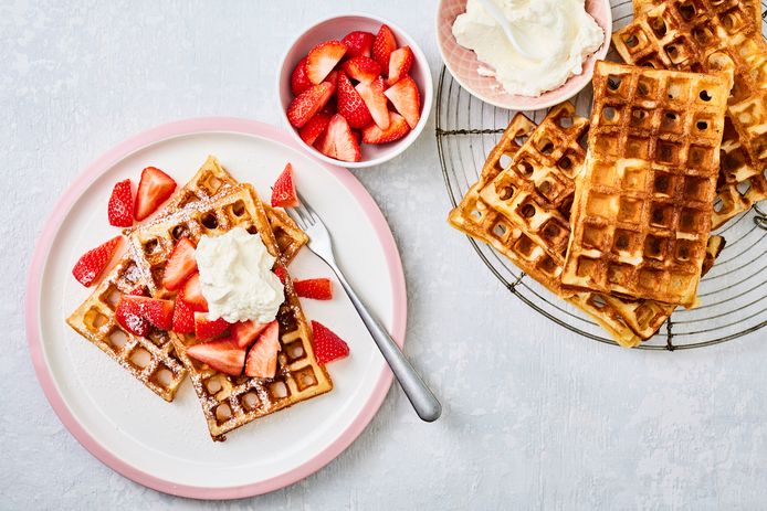 Fresh waffles with whipped cream and strawberries