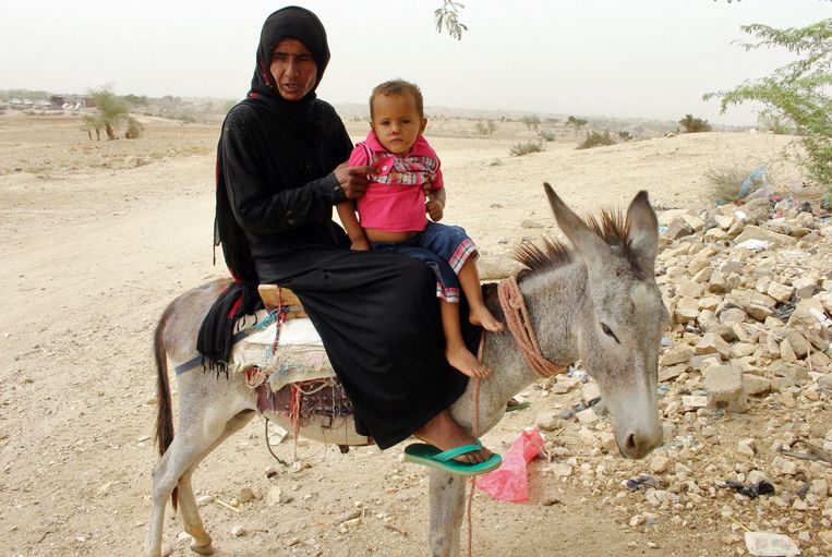 Een vrouw is met haar kind op weg naar een kliniek in Hajjah. Beeld AFP
