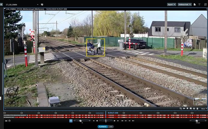 Op de beelden van een technische camera van Infrabel is te zien hoe een dame met buggy de gesloten slagbomen negeert en het spoor kruist. In de verte zie je de trein naderen.
