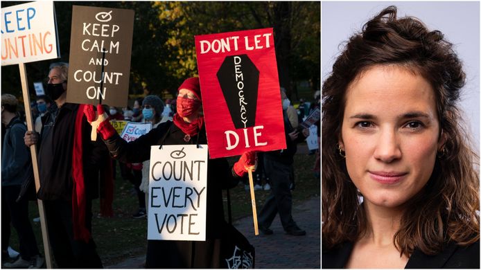 Mensen in Boston in de VS demonstreren voor het tellen van álle stemmen. 'Laat de democratie niet sterven', zo staat er op het rode bord te lezen.