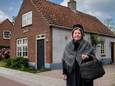 Hannie van Wijk voor haar huis uit 1909, in haar bakerkledij ofwel kleren van een verloskundige. ,,Het verleden intrigeerde me altijd al.”