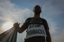Un homme tient une bannière lors d'une manifestation contre les violents refoulements de migrants, prétendument effectués par la police croate, près du poste frontière entre la Croatie et la Bosnie-Herzégovine à Maljevac, en Croatie, samedi 19 juin 2021.