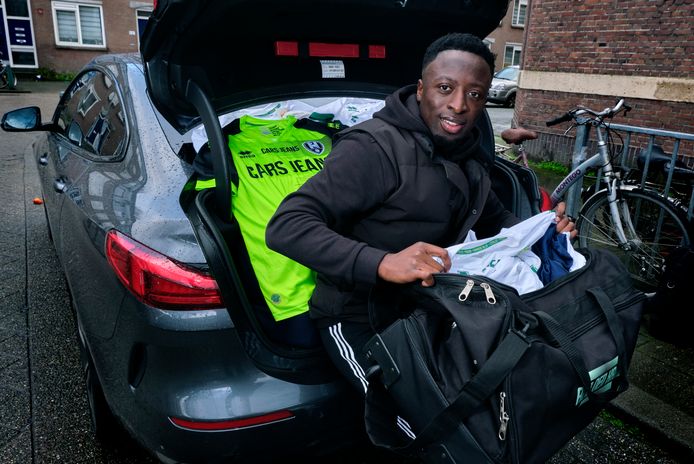 Voetballer Robin Polley met een achterbak en sporttassen vol voetbalshirts, bestemd voor Ghana.