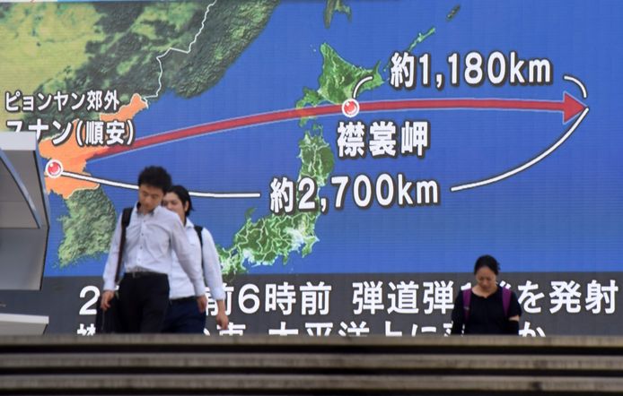 Inwoners van Tokio wandelen langs een groot tv-scherm waarop de laatste Noord-Koreaanse test in kaart wordt gebracht.