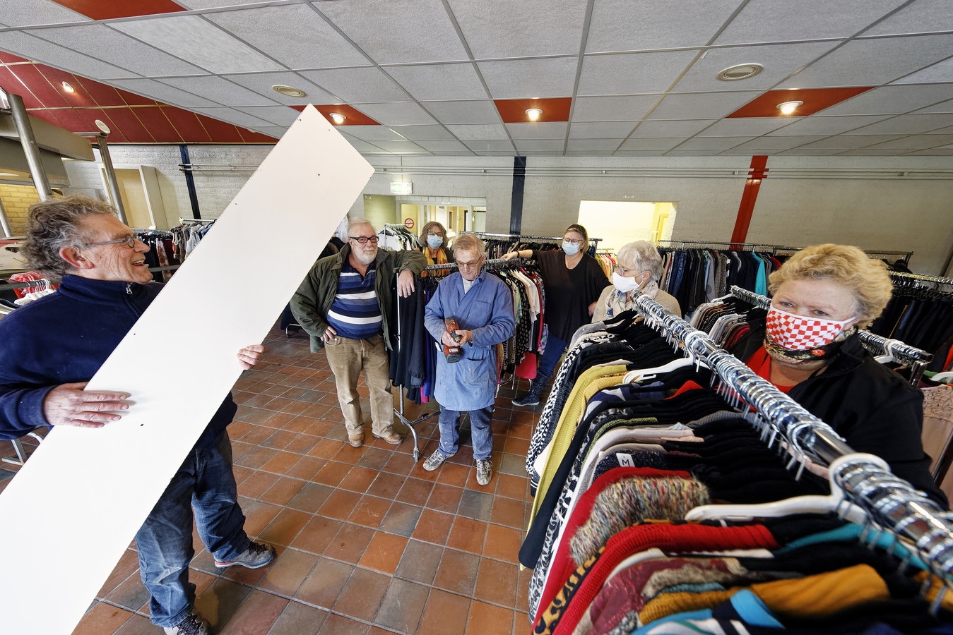 Vrijwilligers aan het werk om de nieuwe kledingbank Gestels Goei Goed op orde te krijgen in de kantine van SCI op Heidelust.