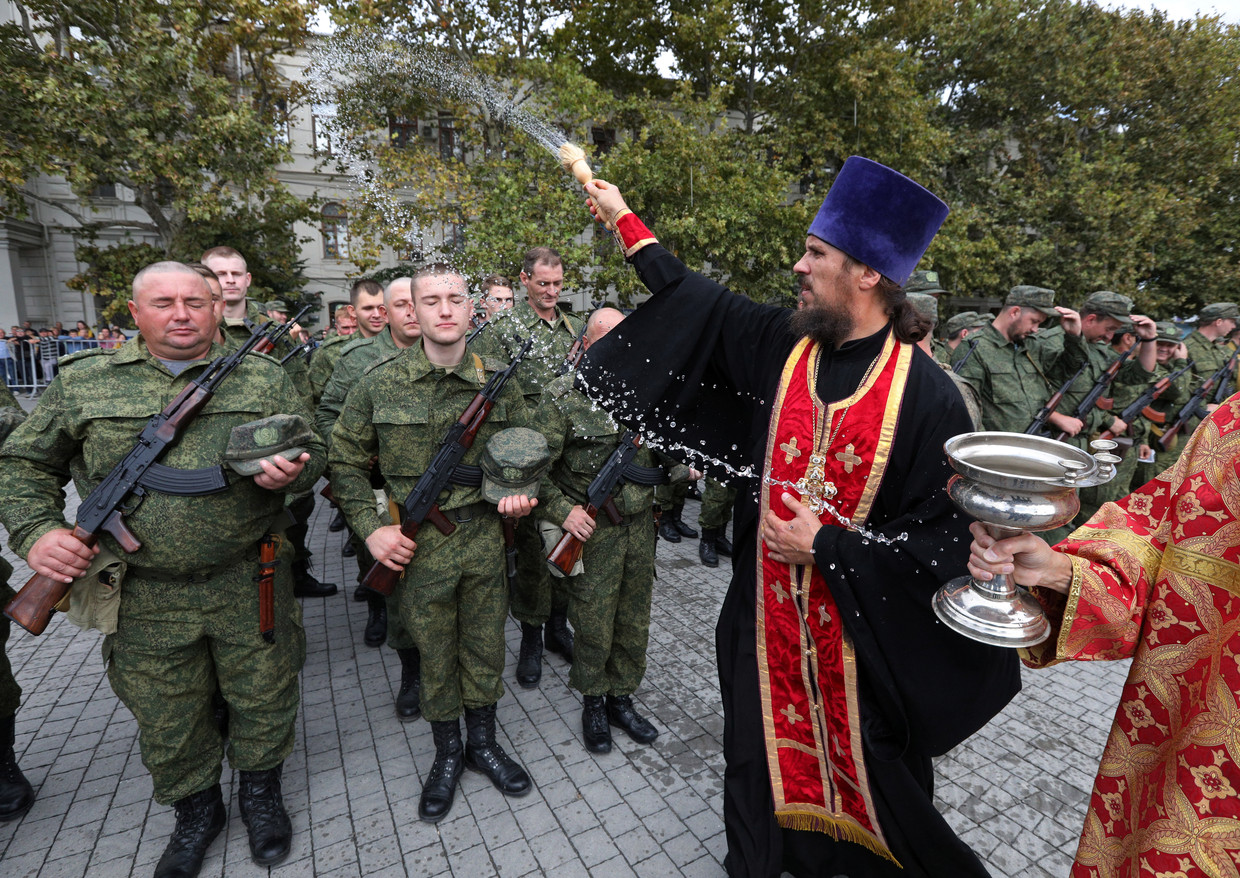 An Orthodox priest leads a service for reservists called up as part of a partial mobilization, during the ceremony of their departure for military bases, in Sevastopol.  Reuters photo