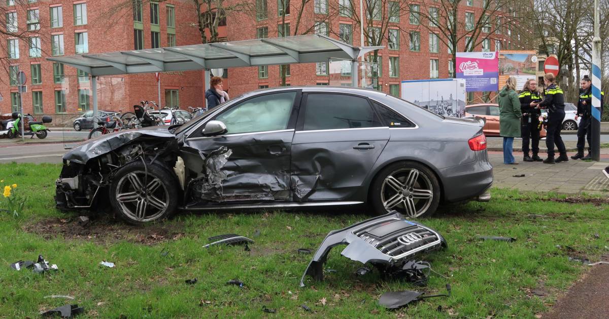 Ongeluk met twee auto’s in Breda, stoep en fietspad bezaaid met brokstukken.