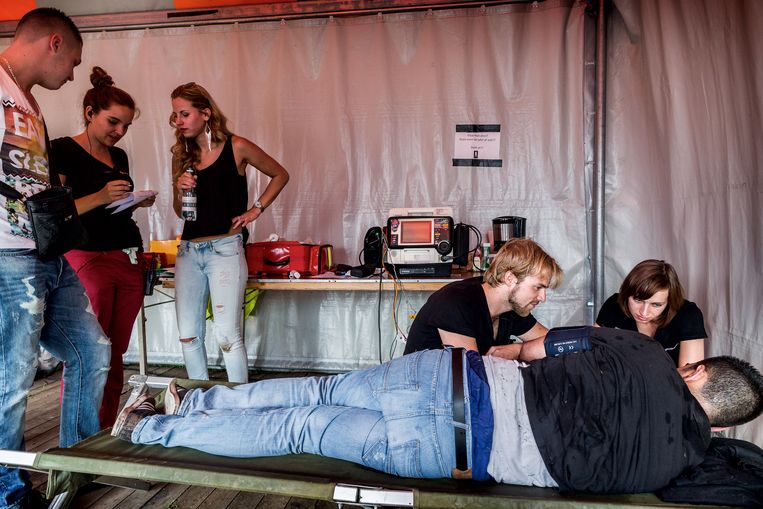 Festivalzusters zijn pas afgestudeerde of nog afstuderende geneeskundestudenten, die op festivals de ambulancebroeders vervangen, omdat zij denken beter in te kunnen spelen op de hulp die festivalgangers nodig hebben. Op de foto helpt 'Festivalzuster' Alex een jongen die kort daarvoor ‘out’ is gegaan op het festivalterrein. Beeld Hollandse Hoogte / Rink Hof