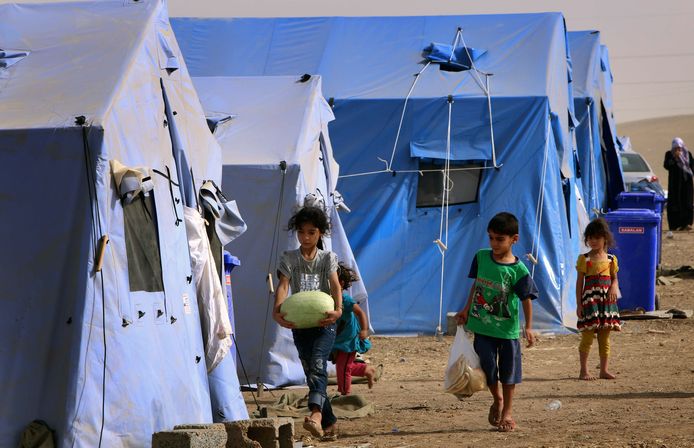 Children walk outside temporary tents set up to shelter Iraqis fleeing violence in Iraq's northern Nineveh province in Aski kalak, 40 kms West of Arbil, in the autonomous Kurdistan region, on June 12, 2014. Thousands of people who fled Iraq's second city of Mosul after it was overrun by jihadists wait in the blistering heat, hoping to enter the safety of the nearby Kurdish region and furious at Baghdad's failure to help them.  many as half a million people are thought to have fled Mosul, which was captured by the Islamic State of Iraq and the Levant (ISIL) Tuesday after a spectacular assault that routed the army. AFP PHOTO/SAFIN HAMED