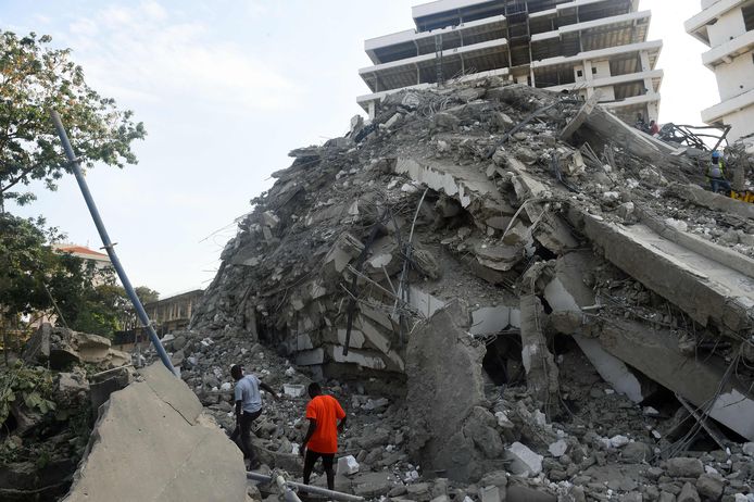 Reddingswerkers tussen het puin van het ingestorte flatgebouw in aanbouw in Lagos.