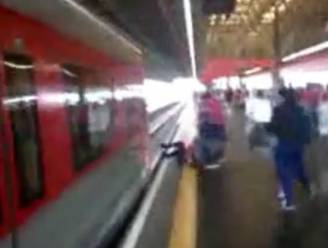 Vrouw springt op sporen voor gevallen gsm en wordt net niet overreden door trein