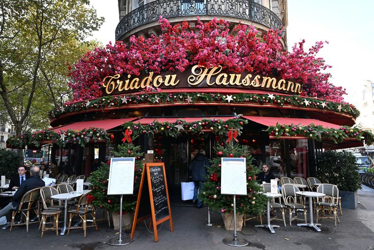 De façade van dit Parijse café is, net als vele andere, gedecoreerd met hopen nepbloemen. Beeld ANP / AFP