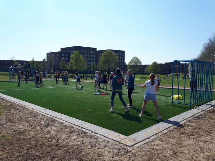 Kinderen van Jenaplanschool Antonius Abt spelen op het nieuwe kunstgrasveld.