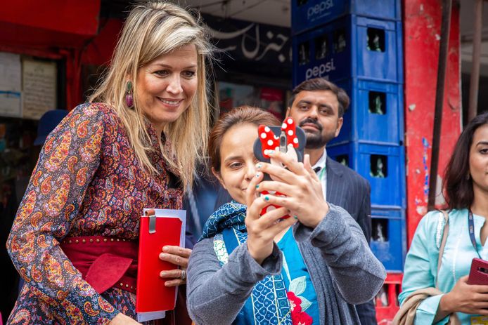 Koningin Máxima gaat op de foto na een bezoek aan de eigenaar van een supermarkt op de Ghalib Markt in Lahore gisteren.