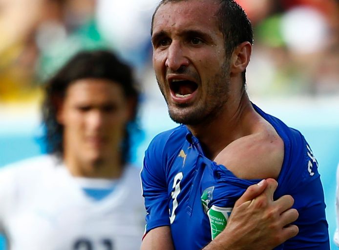 Italy's Giorgio Chiellini shows Luis Suarez his teeth at the 2014 World Cup.