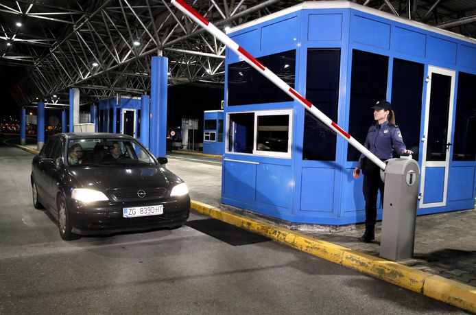 A Croatian border guard opens the border between Croatia and Slovenia for the last time.  As of today, the borders will remain open.