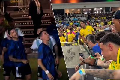 KIJK. Di María spuwt richting Braziliaanse fans nadat die Argentijnen op bierdouche trakteerden