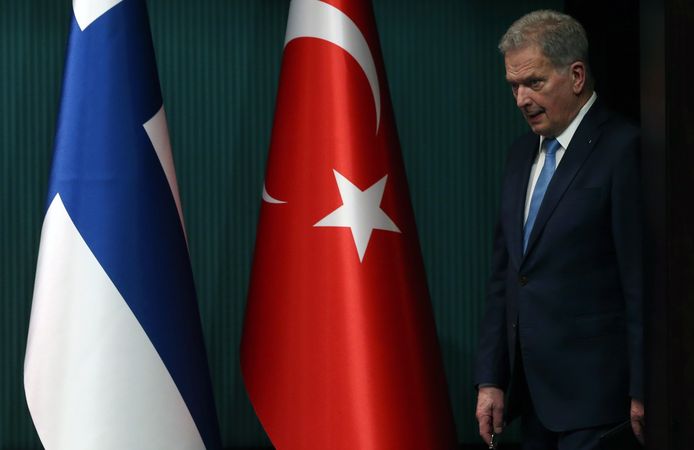 Le président finlandais Sauli Niinisto à côté des drapeaux turc et finlandais.