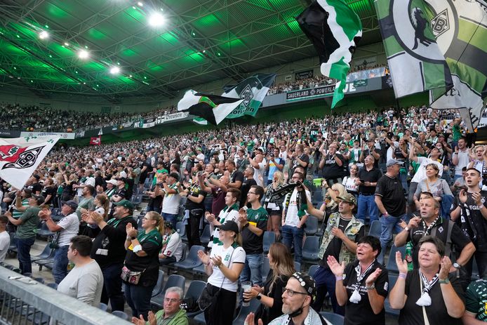Spectators cheer during the German Bundesliga soccer match between Borussia Moenchengladbach and Bayern Munich in Moenchengladbach, Germany, Friday, Aug. 13, 2021. (AP Photo/Martin Meissner)