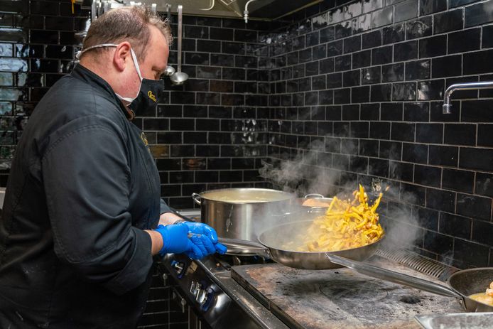 Bjorn schudt de pan met gabakken appel en spek voor een van de slaatjes.