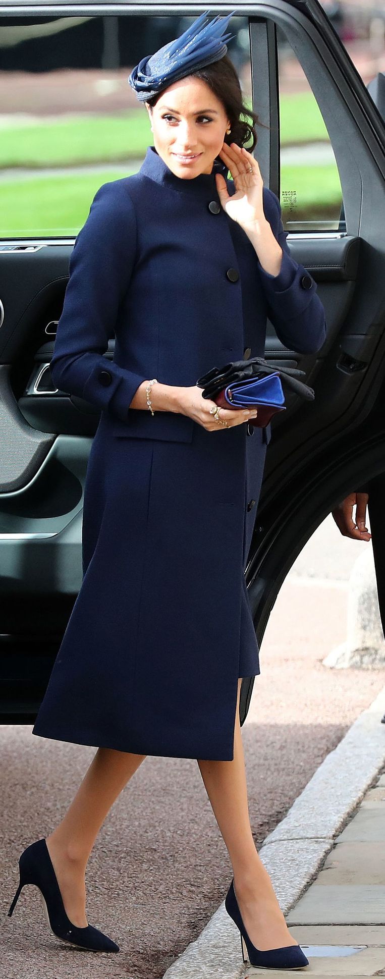 Meghan droeg vrijdag een wijde mantel, vermoedelijk om een beginnend babybuikje te verstoppen. Beeld AFP