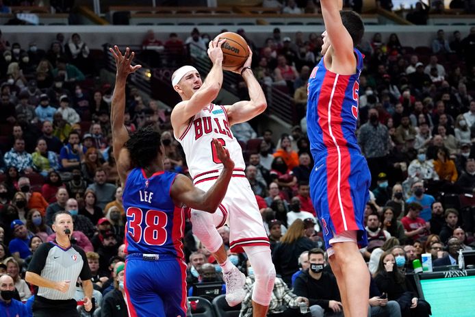 Chicago Bulls guard Alex Caruso, center, looks to a pass against Detroit Pistons guard Saben Lee, left, and center Luka Garza during the second half of an NBA basketball game in Chicago, Saturday, Oct. 23, 2021. (AP Photo/Nam Y. Huh)