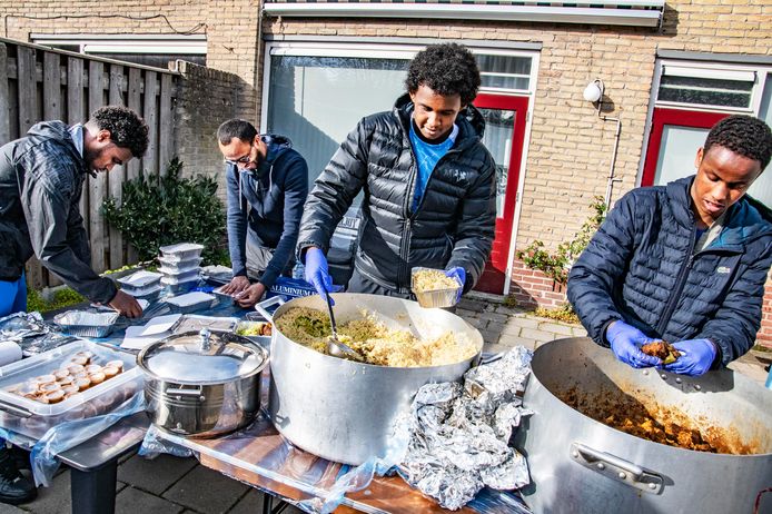 Tweede van links is Markaz Ummah, die op een binnenplaats in Tilburg Noord de iftar maaltijden verpakt.