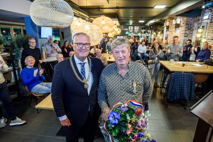 Theo Busch (r.), voorzitter van voetbalvereniging Vogido, werd blij verrast met de koninklijke onderscheiding die loco-burgemeester Arjan Kampman hem opspeldde.