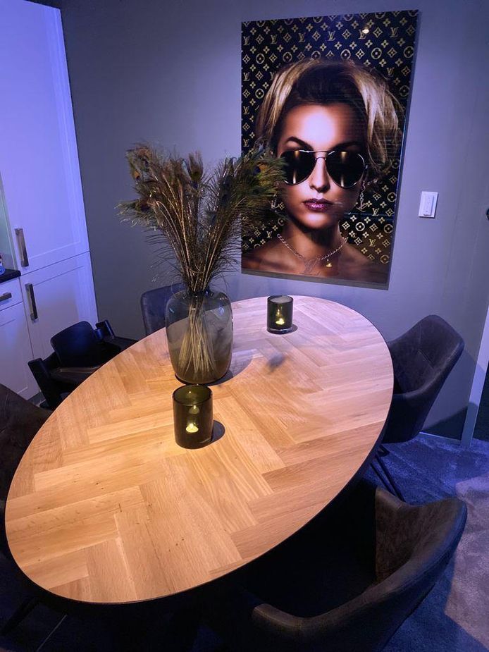 Een ovalen tafel met visgraatpatroon.