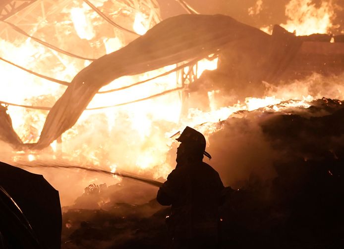 A firefighter works to extinguish a fire at the Central de Abasto wholesale market, the main food distribution center in Mexico City, Thursday, April 6, 2023. (AP Photo/Eduardo Verdugo)