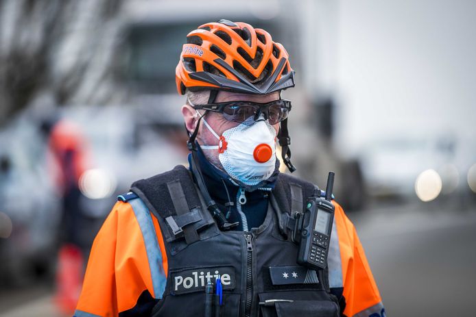 Een Belgische politieagent met een mondkapje.