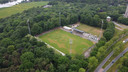 Stadion De Wageningse Berg tussen de bomen en aan de rivier de Rijn.