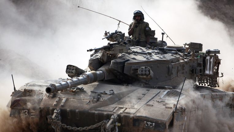 Een tank van het Israëlische leger rolt de grens bij de Gazastrook over. Beeld afp