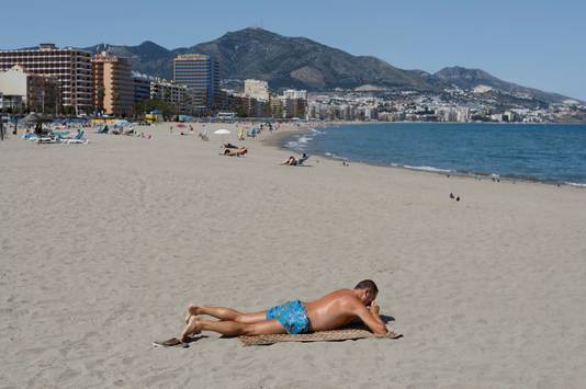 Een man op het strand in Spanje.