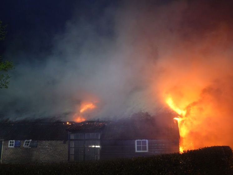 Bewoners kijken aangeslagen toe hoe hun boerderij volledig afbrandt