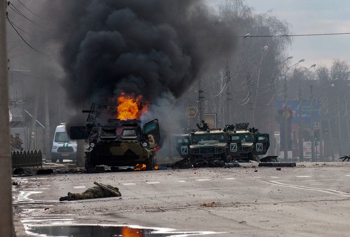 Een Russisch legervoertuig brandt uit in de straten van Charkov.