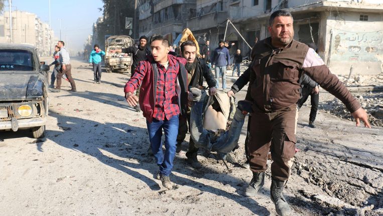Inwoners van de stad Aleppo dragen een lichaam. Beeld afp
