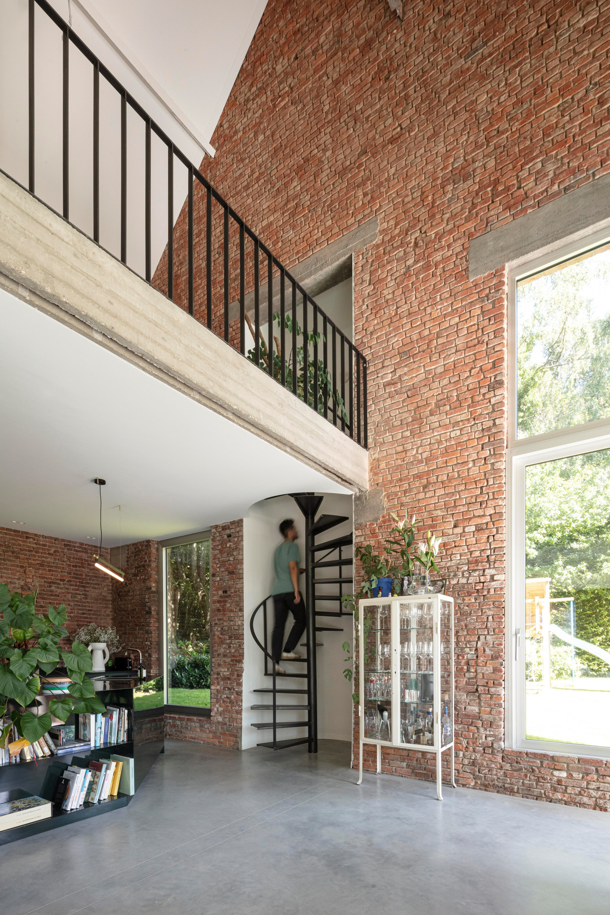 The dark green kitchen is made of enameled steel plates.  The stairs lead to Stefan's desk.  Tim van de Velde's photo