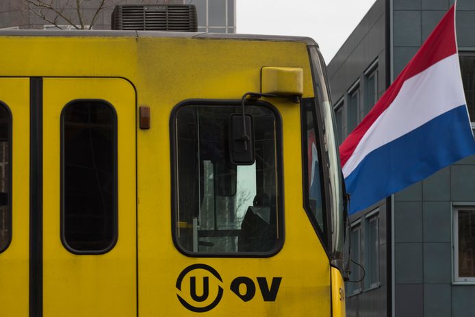 Een tram passeert in Utrecht een vlag die halfstok hangt.