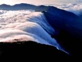 Waterval van wolken stroomt over natuurgebied in China