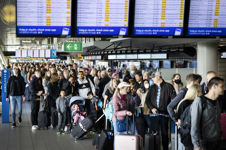 Reizigers in een vertrekhal van Schiphol. Door personeelstekorten werd al grote drukte verwacht, maar door een staking ontstond een totale chaos op de luchthaven. Beeld ANP