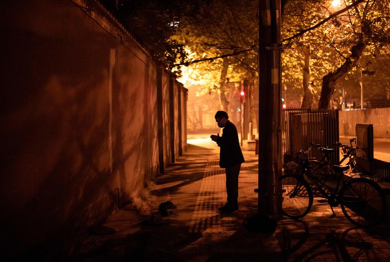 Een inwoner van Wuhan in gebed. Beeld AFP