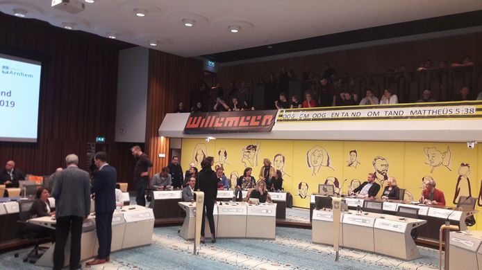 Spandoeken op de publieke tribune in de raadszaal van de gemeente Arnhem. Aanhangers van jongerencentrum Willemeen zetten met die uitingen hun roep kracht bij om het werk in het centrum niet op te knippen.