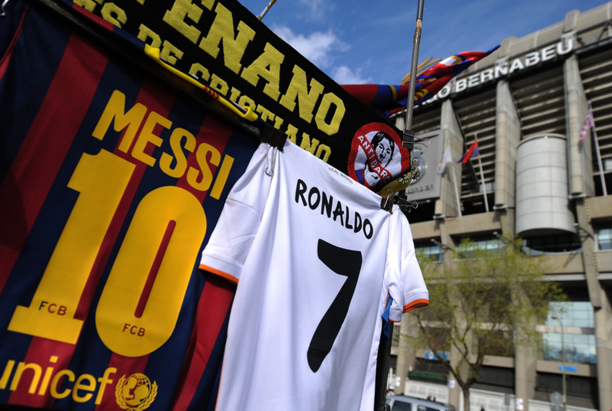 De shirtjes van Lionel Messi en Cristiano Ronaldo zijn uitgestald op zondag bij het stadion Santiago Bernabeu in Madrid Beeld getty