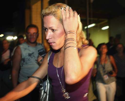 Carla, l'un des trois travestis, traquée par les journalistes brésiliens lors de son arrivée au commissariat de police de Barra da Tijuca (Rio de Janeiro).