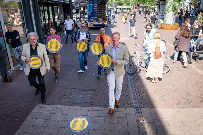 Coronamarkering op het wegdek in het centrum van Arnhem. Vooraan wethouder Jan van Dellen (rechts) en Gerard Velthuizen, voorzitter van Platform Binnenstad Arnhem.