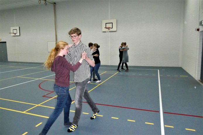 Juliëtte en Gijs dansen met veel plezier de quickstep in de gymzaal van Gymnasium Beekvliet.